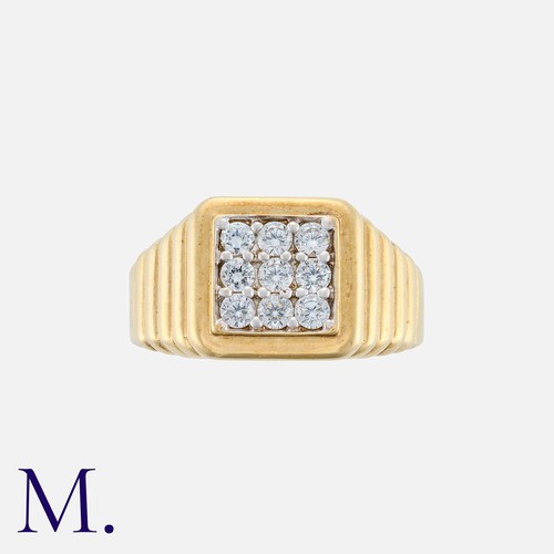 112 - A Gold Ring with stepped shoulders in 9K yellow gold set with nine cubic zirconia stones.  Hallmarke... 