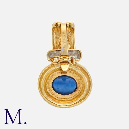 73 - A Sapphire And Diamond Pendant in 18k yellow gold, set with a cabochon sapphire of approximately 4.3... 