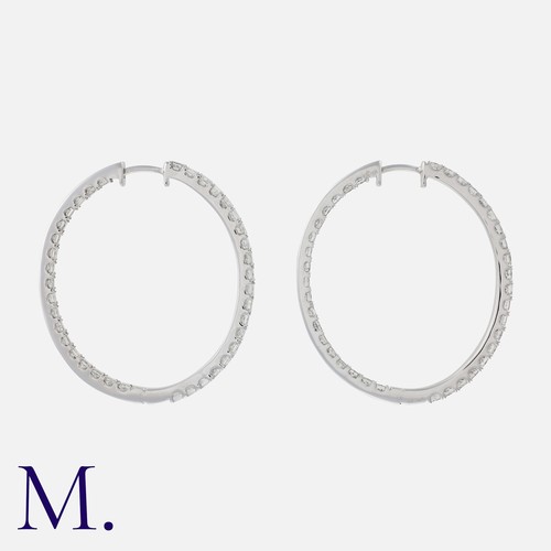 151 - A Large Pair Of Diamond Hoop Earrings in 14k white gold, set with princess cut diamonds totalling ap... 