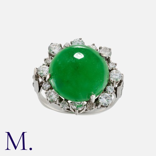 166 - A Jade And Diamond Cluster Ring in platinum, set with a principal jade cabochon of approximately 10.... 