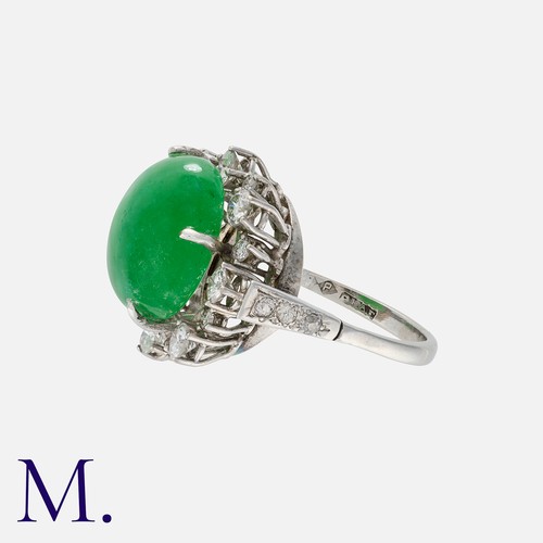 166 - A Jade And Diamond Cluster Ring in platinum, set with a principal jade cabochon of approximately 10.... 