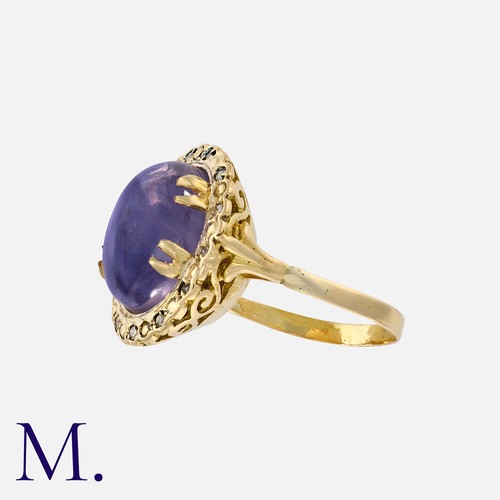 46 - A Star Sapphire And Diamond Ring in yellow gold, set with a principal cabochon star sapphire of appr... 