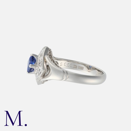 36 - A Sapphire And Diamond Ring in platinum, set with a principal kite shaped sapphire of approximately ... 