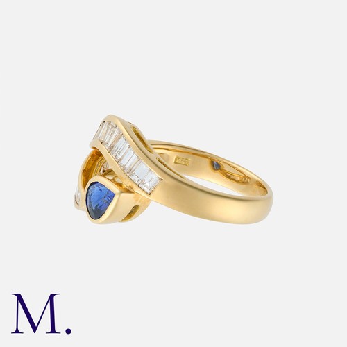 144 - A Sapphire And Diamond Ring in 18k yellow gold, of crossover design, set with a pear shaped sapphire... 