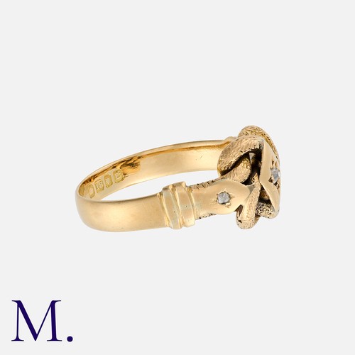 18 - An Antique Lovers Knot Ring in 18 carat yellow gold, the knotted form set with a central old cut dia... 