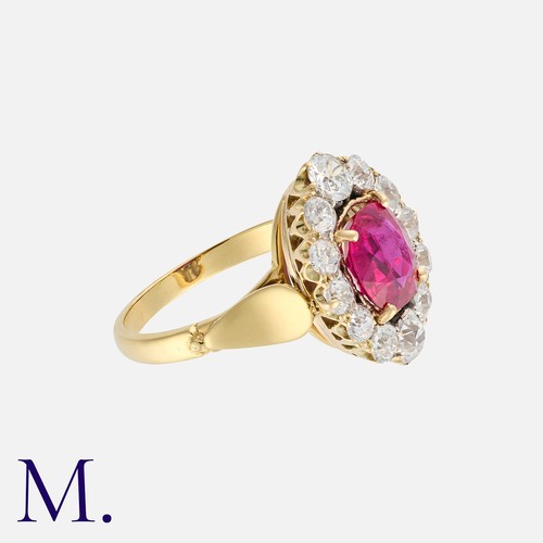 50 - A Fine Burma No Heat Ruby And Diamond Cluster Ring, in yellow gold, set with a principal cushion cut... 