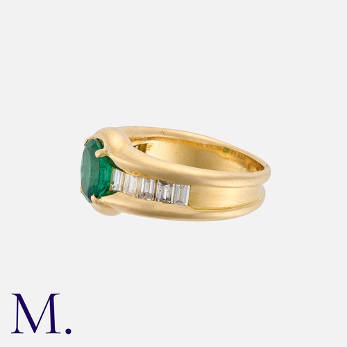 67 - An Emerald and Diamond Ring in yellow gold, set with a forest green oval-cut emerald to the centre w... 