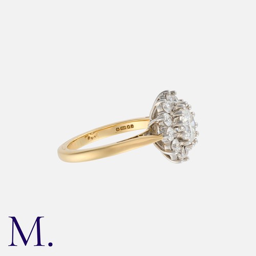 194 - A Diamond Cluster Ring in 18k yellow gold, set with a principal round cut diamond of approximately 1... 