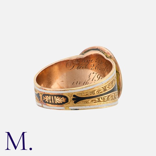 148 - An Antique Enamel Mourning Ring in yellow gold, the finely engraved mount featuring black and white ... 