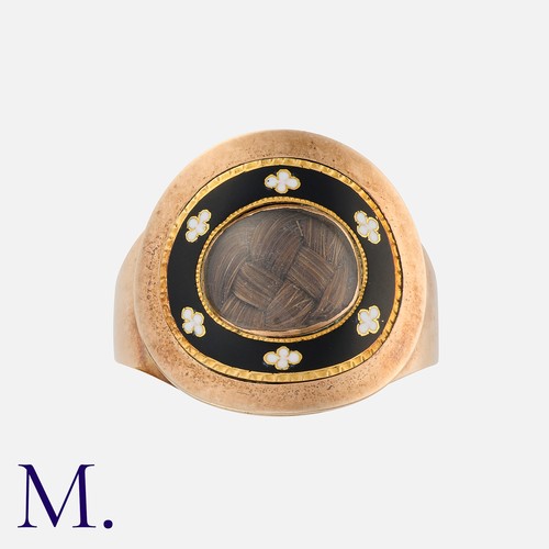 187 - An Antique Enamel And Hairwork Mourning Ring in yellow gold, with black and white enamel decoration,... 