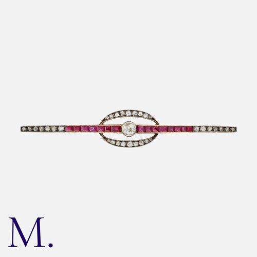 110 - A Ruby And Diamond Brooch in yellow gold and silver, set with a principal diamond of approximately 0... 