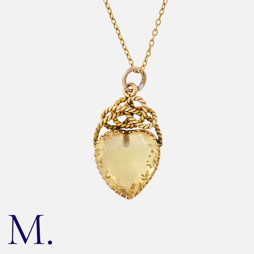 90 - An Antique Citrine Heart Pendant in 9K yellow gold, set with a heart-shaped citrine to an ornate bal... 