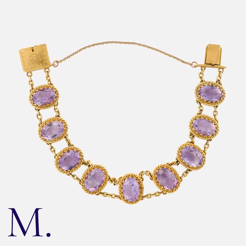 208 - An Antique Amethyst Bracelet in yellow gold, set with nine oval-cut amethysts to rope design surroun... 