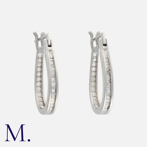 126 - A Pair of Diamond Hoop Earrings in white gold, set with baguette cut diamonds.

Size: 2.2cm
Weight: ... 