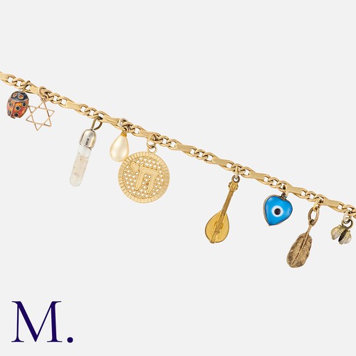 93 - A Charm Bracelet in yellow gold, set with various charms. Bracelet clasp marked '585' indicating 14K... 