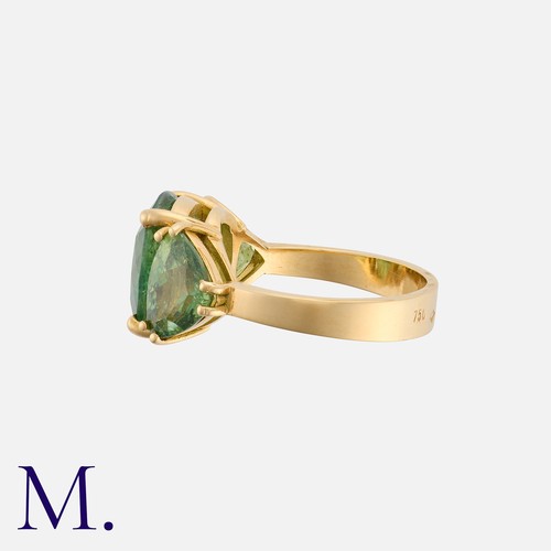 210 - A Demantoid Garnet 3-Stone Ring in 18K yellow gold, set with a principal cushion-cut garnet weighing... 