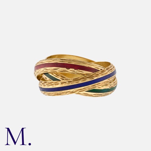 211 - HERMES. A Triple Ring in 18K yellow gold with each band enameled in red, green and blue.  Signed Her... 