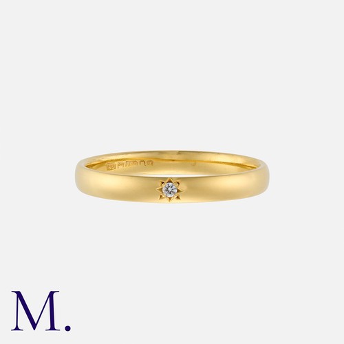 221 - A Diamond-Set Band in 18K yellow gold, with a small accent diamond flush-set to the band.  Hallmarke... 