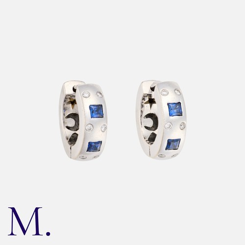 159 - A Pair Of Sapphire And Diamond Hoop Earrings in 18k white gold, of 'huggie' hoop design set with squ... 