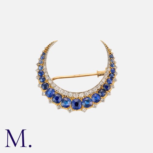 174 - An Antique Sapphire and Diamond Crescent Brooch in 18K yellow and white gold, set with 21 cushion cu... 