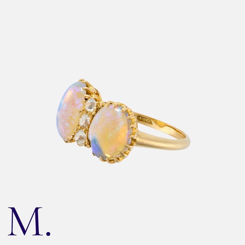 24 - An Antique French Opal And Diamond Ring in 18k yellow gold, set with a trio of old cut diamonds, fla... 