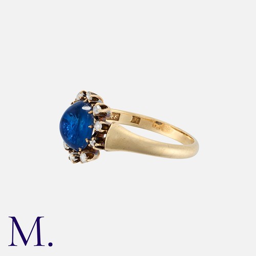 97 - A Cabochon Sapphire And Diamond Ring in 14k yellow gold, set with a. central cabochon sapphire of ap... 