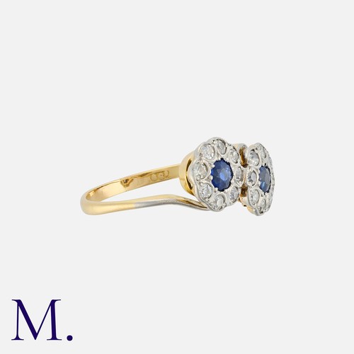 45 - A Double Sapphire And Diamond Cluster Ring in 18k yellow gold, set with two round cut sapphires with... 