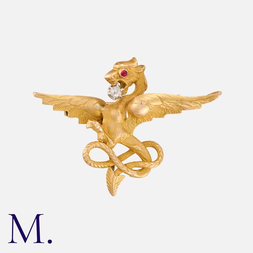 175 - An Antique Chimera Brooch in yellow gold. set with an accent diamond and ruby.  Unmarked but tests i... 