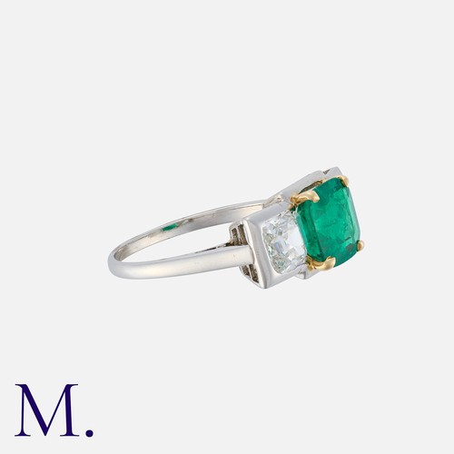 119 - A Columbian Emerald and Diamond Ring in platinum, set with facetted square cut emerald (accompanied ... 