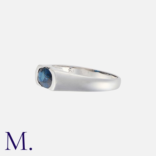 66 - A Sapphire Ring in 18k white gold, set with an oval cut blue sapphire. Marked 750 for 18 carat gold.... 