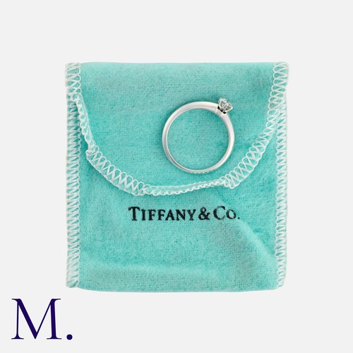 11 - TIFFANY & CO., A Diamond Solitaire Ring in platinum, set with a round cut diamond of approximately 0... 