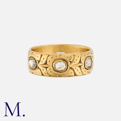 142 - An Antique Engraved Diamond Band in yellow gold, the band engraved with a repeating floral pattern a... 