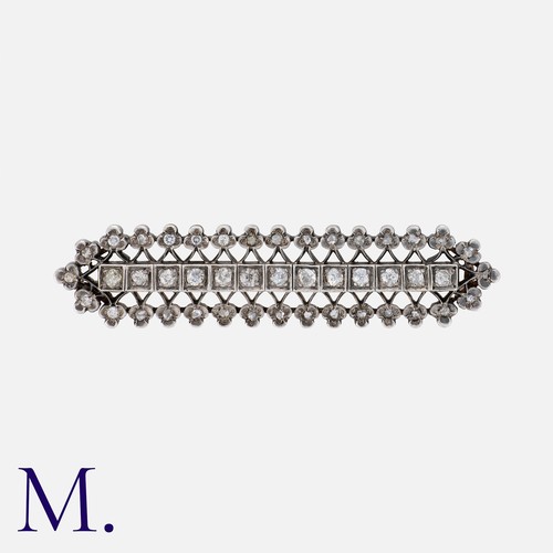 70 - An Antique Diamond Brooch in silver and gold, set with old cut diamonds to the centre weighing appro... 