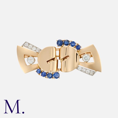 108 - A Retro Sapphire And Diamond Double Clip Brooch in yellow gold, comprising two clips, fastening to a... 