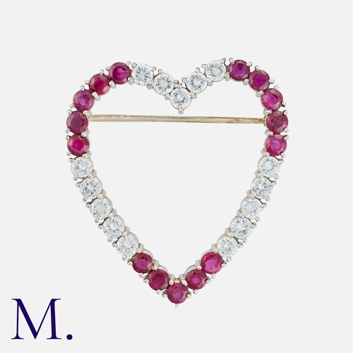 71 - A Ruby and Diamond Heart Brooch in white gold set with round cut diamonds weighing approximately 2.2... 