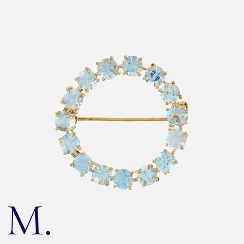 158 - An Aquamarine Brooch in 18k yellow gold, designed as a circle, set with round cut aquamarines. Marke... 