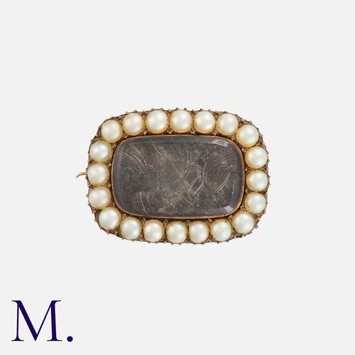 125 - A Pearl And Hairwork Mourning Brooch in yellow gold, set with a woven hairwork within a border of ro... 