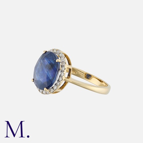 129 - A Sapphire And Diamond Cluster Ring in 14k yellow gold, set with a principal oval cut sapphire of ap... 