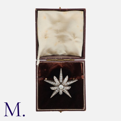 14 - An Antique Diamond Star Brooch in yellow gold and silver, set with old cut diamonds, the principal o... 