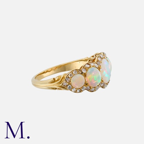 186 - An Opal And Diamond Ring in 14k yellow gold, set with five cabochon opals within a border of rose cu... 