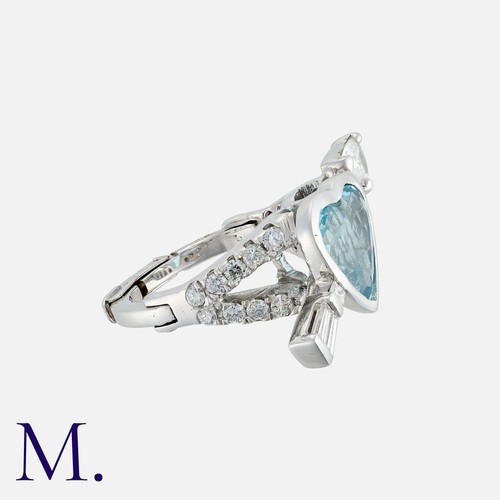 194 - An Aquamarine And Diamond Ring in 14k white gold, set centrally with a heart shaped aquamarine, with... 