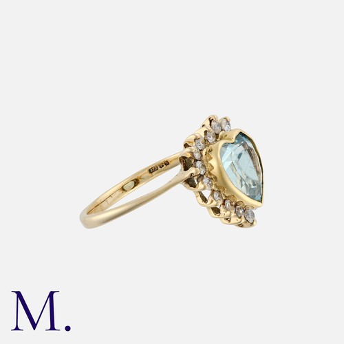 144 - An Aquamarine And Diamond Ring in 9k yellow gold, set with a heart shaped aquamarine within a cluste... 