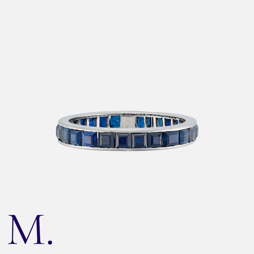 163 - A Sapphire Eternity Ring in white gold, set with calibre cut sapphires. Unmarked, tests indicate 18 ... 