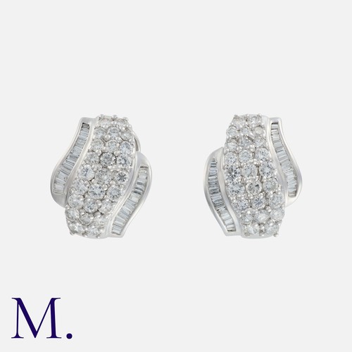 180 - A Pair Of Diamond Set Hoop Earrings in 18k white gold, set with round cut diamonds and tapered bague... 