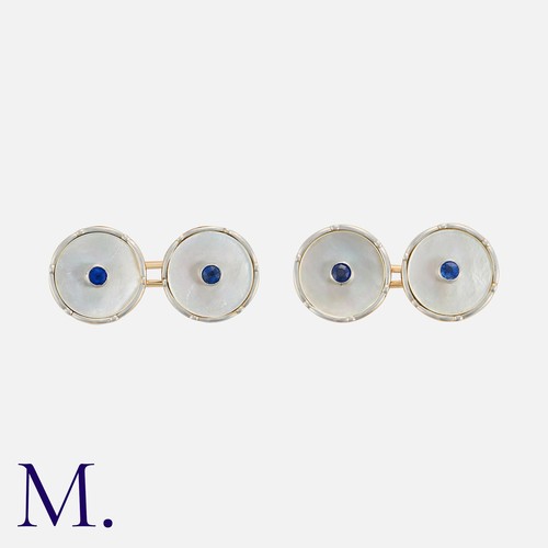 173 - A Pair Of Mother Of Pearl And Sapphire Cufflinks in 9k yellow gold, of circular design, set with rou... 