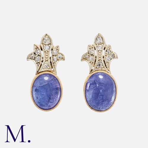 59 - A Pair Of Tanzanite And Diamond Earrings in 14k yellow gold, each set with a large cabochon tanzanit... 