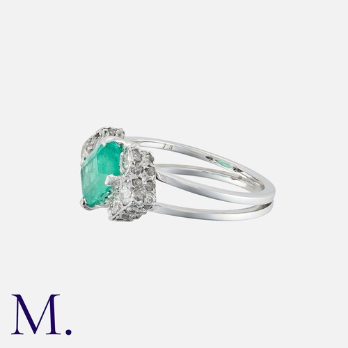 41 - A Colombian Emerald And Diamond Ring in 18k white gold, set with an octagonal cut emerald of approxi... 