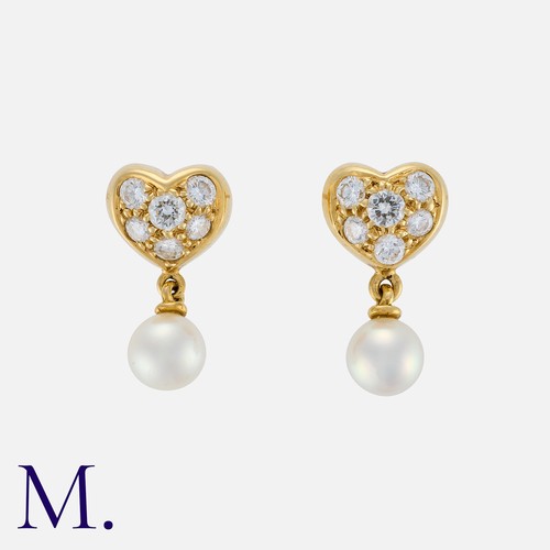 90 - TIFFANY & CO. A Pair of Diamond and Pearl Earrings in 18K yellow gold, with heart form tops set with... 