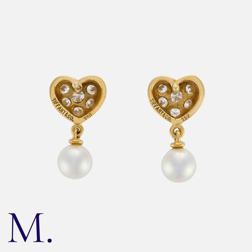 90 - TIFFANY & CO. A Pair of Diamond and Pearl Earrings in 18K yellow gold, with heart form tops set with... 