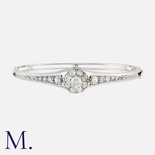 118 - A Diamond Bangle in 18K white gold, set with old cut diamonds in a cluster to the centre (principal ... 